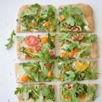 Cherry Tomato, Arugula and Herb Pissaladière with Roasted Garlic Cream Sauce