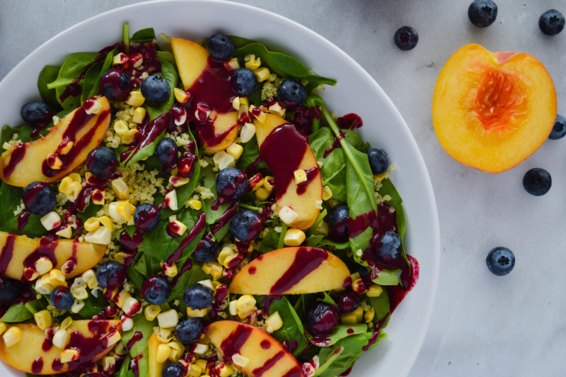 vegan blueberry vinaigrette dressing with millet, peaches and corn